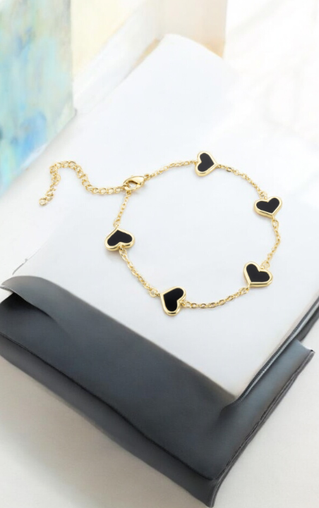 Gold bracelet with black heart