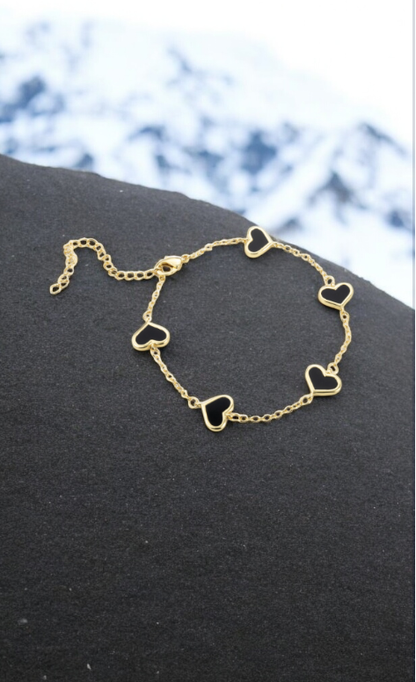 Gold bracelet with black heart