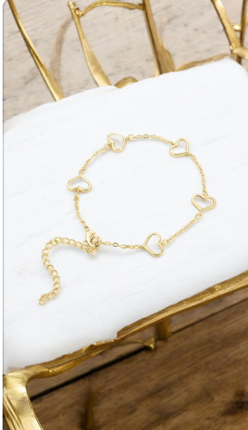 Gold bracelet with white hearts