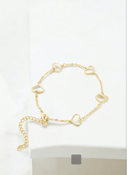 Gold bracelet with white hearts